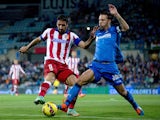 Raul Garcia of Atletico Madrid competes for the ball with Alexis Ruano of Getafe CF during the La Liga match between Getafe CF and Club Atletico de Madrid at Coliseum Alfonso Perez on October 26, 2014