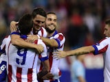 Atletico Madrid players celebrate after scoring their second goal during the UEFA Champions League football match Club Atletico de Madrid vs Malmo FF at the Vicente Calderon stadium in Madrid on October 22, 2014