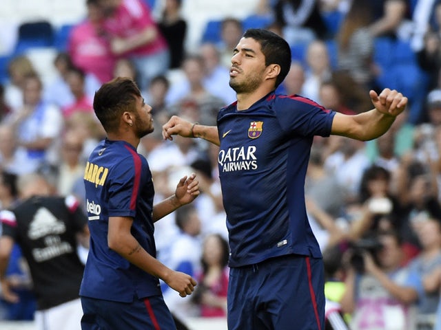 Barcelona's Uruguayan forward Luis Suarez warms up before the Spanish league 'Clasico' football match Real Madrid CF vs FC Barcelona at the Santiago Bernabeu stadium in Madrid on October 25, 2014