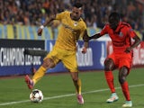 Paris Saint-Germain's midfielder Blaise Matuidi (R) fights for the ball with Apoel FCs defender Mario Sergio (L) during their group F UEFA Champions League football match on October 21, 2014