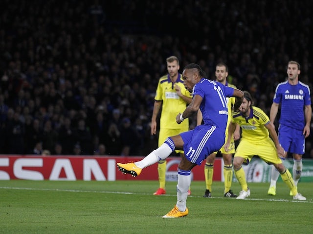 Chelsea's Ivorian striker Didier Drogba scores their second goal from the penalty spot during the UEFA Champions League, Group G, football match on October 21, 2014