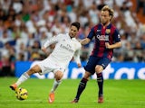 Real Madrid's Isco and Ivan Rakitic of Barcelona battle for the ball during el Clasico at the Bernabeu on October 25, 2014