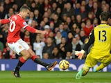 Manchester United's Dutch striker Robin van Persie shoots but Chelsea's Belgian goalkeeper Thibaut Courtois saves during the English Premier League football match between Manchester United and Chelsea at Old Trafford in Manchester, north west England, on 