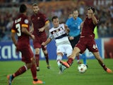 Bayern Munich's midfielder from Germany Mario Goetze (C) kicks to score during the Champions League group stage football match AS Roma vs Bayern Munich on October 21, 2014 