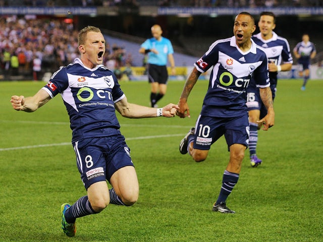 Besart Berisha of the Victory celebrates a goal with Archie Thompson during the round three A-League match between the Melbourne Victory and Melbourne City at Etihad Stadium on October 25, 2014