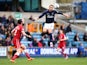 Lee Martin of Millwall jumps to head a ball under pressure from John Brayford of Cardiff during the Sky Bet Championship match between Millwall and Cardiff City at The Den on October 25, 2014