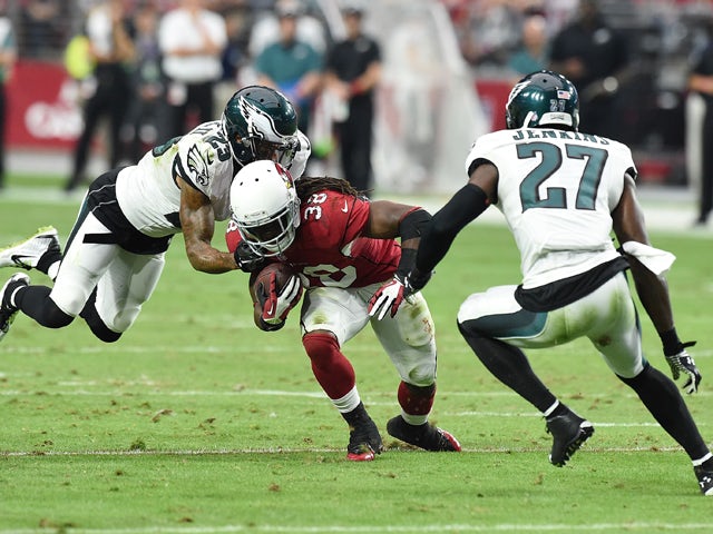 Running back Andre Ellington #38 of the Arizona Cardinals runs the ball against cornerback Nolan Carroll #23 and free safety Malcolm Jenkins #27 of the Philadelphia Eagles in the first quarter of the NFL game at University of Phoenix Stadium on October 26