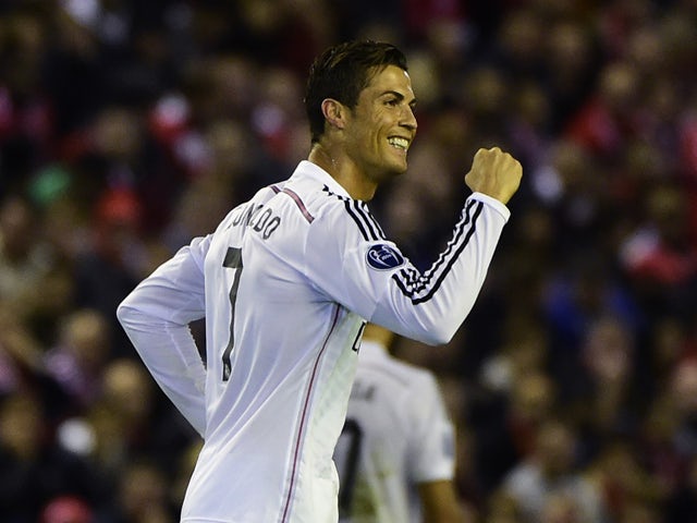 Real Madrid's Portuguese forward Cristiano Ronaldo celebrates scoring the opening goal during the UEFA Champions League, group B, football match between Liverpool and Real Madrid at Anfield in Liverpool, northwest England, on October 22, 2014