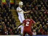 Real Madrid's French forward Karim Benzema rises above Liverpool's English defender Glen Johnson to score Real Madrid's second goal during the UEFA Champions League, group B, football match between Liverpool and Real Madrid at Anfield in Liverpool, northw