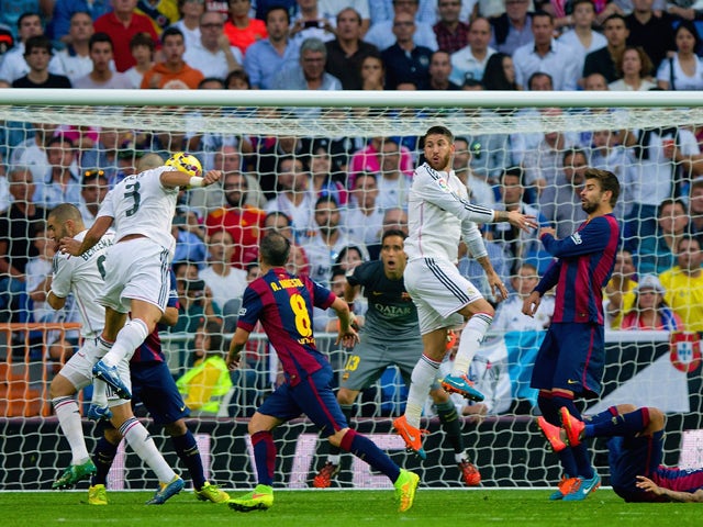 Pepe of Real Madrid CF heads in their second goal during the La Liga match between Real Madrid CF and FC Barcelona at Estadio Santiago Bernabeu on October 25, 2014