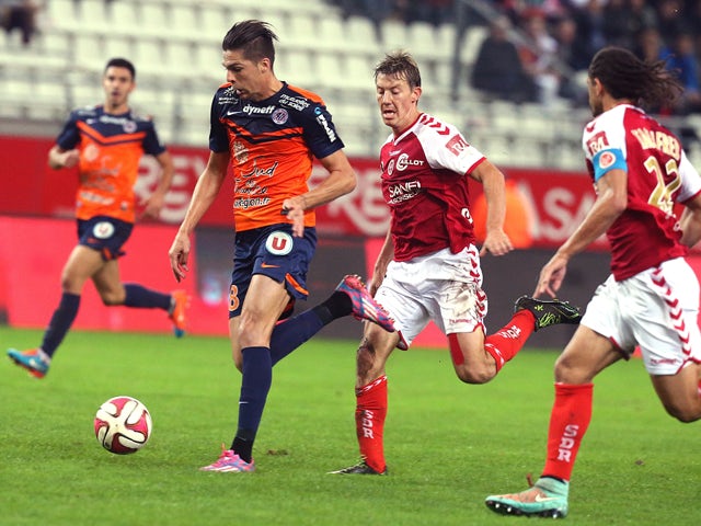 Reims' French defender Franck Signorino vies with Montpellier's French midfielder Jonas Martin during the French L1 football match Reims vs Montpellier, on October 25, 2014