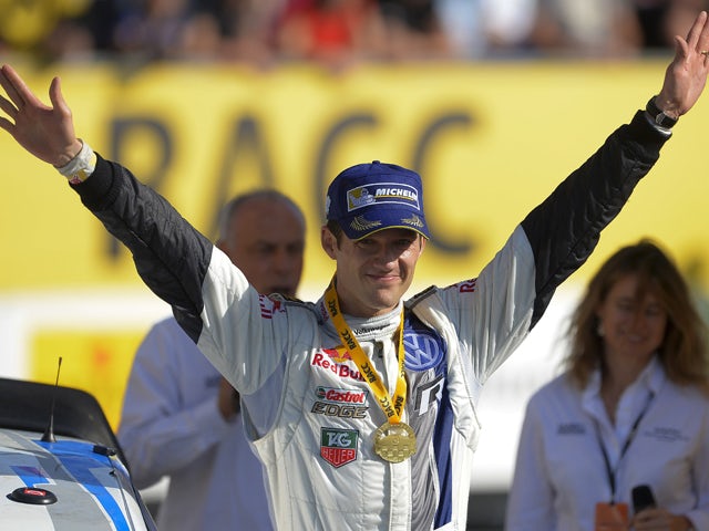 :French driver Sebastien Ogier celebrates after winning the 50th Rally of Catalonia and retaining his world title in Salou, near Tarragona, on October 26, 2014.