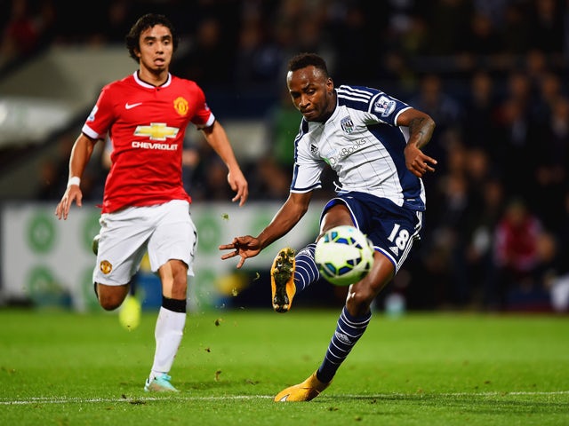 Saido Berahino of West Bromwich Albion scores their second goal as Rafael of Manchester United looks on during the Barclays Premier League match between West Bromwich Albion and Manchester United at The Hawthorns on October 20, 2014