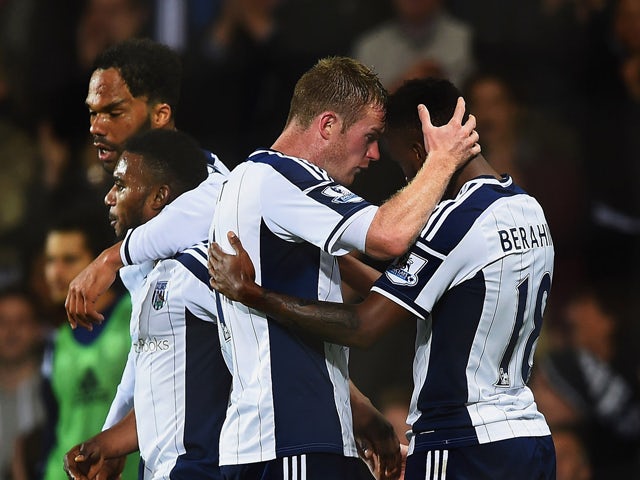 Saido Berahino of West Bromwich Albion celebrates with team mate Chris Brunt as he scores their second goal during the Barclays Premier League match between West Bromwich Albion and Manchester United at The Hawthorns on October 20, 2014