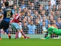 West Ham United's French midfielder Morgan Amalfitano turns the ball in to score the opening goal past the diving Manchester City's English goalkeeper Joe Hart during the English Premier League football match between West Ham United and Manchester City at