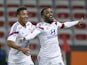 Lyon's French forward Alexandre Lacazette (R) celebrates with Lyon's French midfielder Corentin Tolisso (L) after scoring a goal during the French first division L1 football match against Nice on November 1, 2014