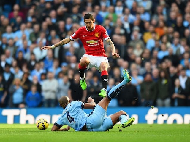 Angel di Maria of Manchester United leaps over a challenge from Vincent Kompany of Manchester City during the Barclays Premier League match at the Etihad on November 2, 2014