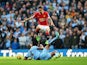 Angel di Maria of Manchester United leaps over a challenge from Vincent Kompany of Manchester City during the Barclays Premier League match at the Etihad on November 2, 2014