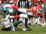 Anthony Fasano #80 of the Kansas City Chiefs dives over Marcus Williams #22 of the New York Jets during the first half at Arrowhead Stadium on November 2, 2014