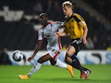 Ben Davies of Sheffield United looks to the ball with Samir Carruthers of MK Dons during the Capital One Cup Fourth Round match on October 28, 2014