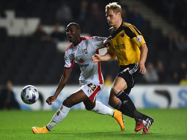 Ben Davies of Sheffield United looks to the ball with Samir Carruthers of MK Dons during the Capital One Cup Fourth Round match on October 28, 2014