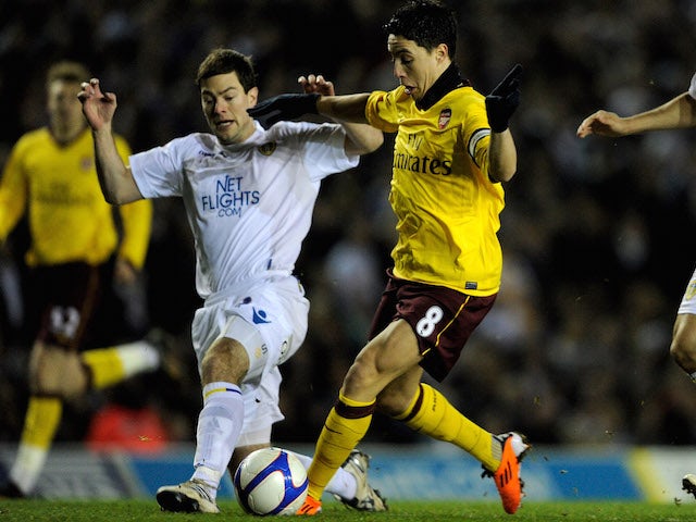 Samir Nasri of Arsenal goes past the challenge of Ben Parker of Leeds United to score the opening goal during the FA Cup third round replay on January 19, 2011