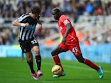 Daryl Janmaat of Newcastle United challenges Mario Balotelli of Liverpool during the Barclays Premier League match on November 1, 2014