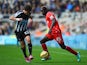 Daryl Janmaat of Newcastle United challenges Mario Balotelli of Liverpool during the Barclays Premier League match on November 1, 2014