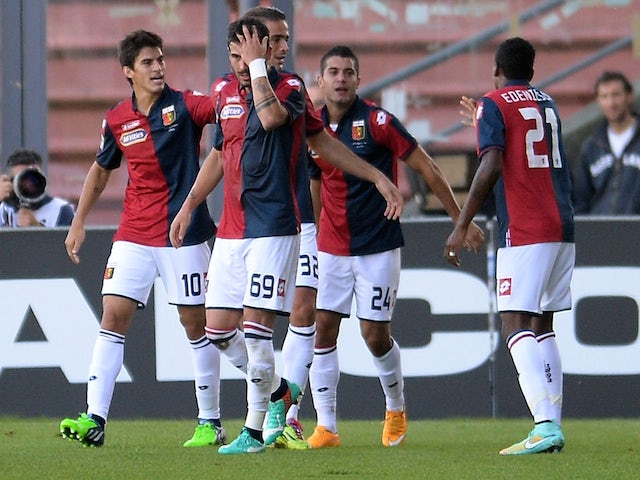 Iago Falque of Genoa CFC is mobbed by team mates after scoring his team's second goal during the Serie A match against Udinese on November 2, 2014