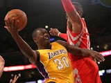 Julius Randle #30 of the Los Angeles Lakers shoots against Dwight Howard #18 of the Houston Rockets at Staples Center on October 28, 2014