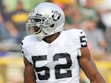Khalil Mack #52 of the Oakland Raiders warms up prior to a preseason game against the Green Bay Packers at Lambeau Field on August 22, 2014