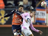 Montpellier's French defender Mathieu Deplagne (L) vies for the ball with Evian's French forward Nicki Nielsen (R) during the French L1 football match on November 1, 2014