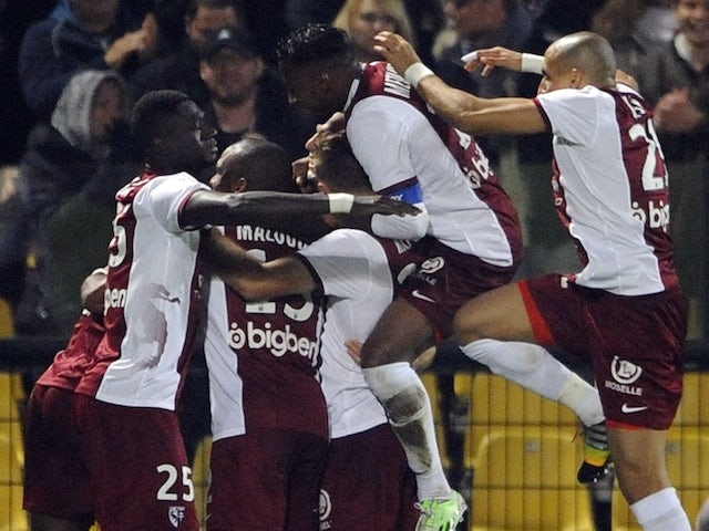 Metz' players celebrate Mali striker Modiba Maïga scoring his second goal during the French first division L1 football match against Caen on November 1, 2014