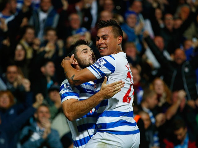 Charlie Austin of QPR celebrates scoring their second goal with Eduardo Vargas of QPR during the Barclays Premier League match between Queens Park Rangers and Aston Villa at Loftus Road on October 27, 2014