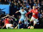 Marcos Rojo of Manchester United slides in as Sergio Aguero of Manchester City and Wayne Rooney battle for the ball during the Barclays Premier League game at the Etihad on November 2, 2014
