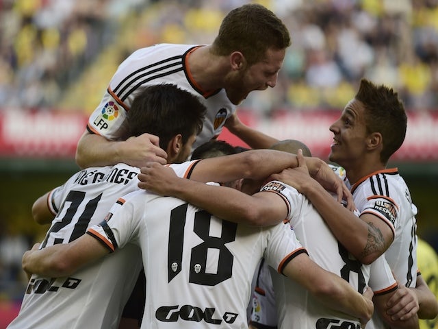 Valencia's players celebrate their first goal during the Spanish league football match Villarreal CF vs Valencia CF at El Madrigal stadium in Villareal on November 2, 2014