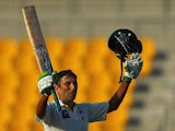 Pakistani batsman Younis Khan celebrates after scoring a century (100 runs) during the first day of the second test cricket match against Australia on October 30, 2014