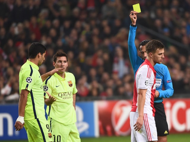 Ajax's Joel Veltman receives a second yellow card during the UEFA Champions League football match between Ajax Amsterdam and FC Barcelona in Amsterdam, on November 5, 2014