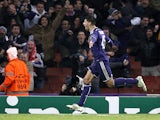 Anderlecht's forward from Serbia Aleksandar Mitrovic celebrates scoring his team's third goal during the UEFA Champions League Group D football match between Arsenal and Anderlecht at the Emirates Stadium in north London on November 4, 2014