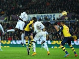 Swansea player Bafetimbi Gomis (c) heads the second Swansea goal during the Barclays Premier League match between Swansea City and Arsenal at Liberty Stadium on November.9, 2014