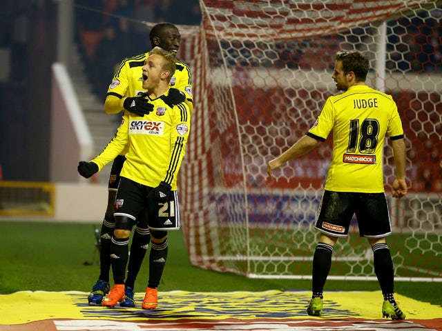 Alex Pritchard of Brentford celebrates scoring the third goal from the penalty spot during the Sky Bet Championship match between Nottingham Forest and Brentford at the City Ground on November 5, 2014