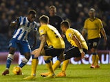 Kazenga Lua Lua of Brighton takes on the Wigan defence during the Sky Bet Championship match between Brighton & Hove Albion and Wigan Athletic at Amex Stadium on November 4, 2014 