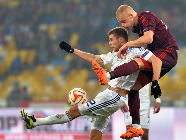 Aalborg BK's Rasmus Thelander fights for a ball against FC Dynamo Kyiv's Artem Kravets during their UEFA Europa League Group J match between FC Dynamo Kyiv vs Aalborg BK in Kiev on November 6, 2014