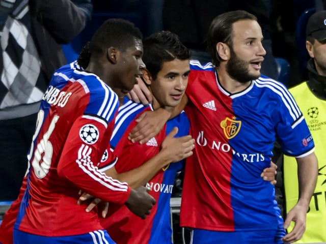 FC Basel's forward Derlis Gonzalez who scores the team's second goal is congratulated by teammates Cameroonian forward Breel Embolo and Albanian forward Shkelzen Gashi during to the UEFA Champions League Group B football match between FC Basel and Ludogor