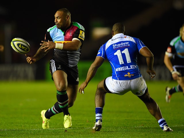 Jordan Turner-Hall of Harlequins passes as Aled Brew of Newport challenges during the LV= Cup match between Harlequins and Newport Gwent Dragons at Twickenham Stoop on November 7, 2014