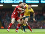 Israel Folau (R)of Australia is held up by George North (L) of Waes during the International match between Wales and Australia at the Millennium Stadium on November 8, 2014