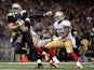 Jimmy Graham #80 of the New Orleans Saints is brought down by Chris Borland #50 of the San Francisco 49ers during the third quarter of a game on November 9, 2014