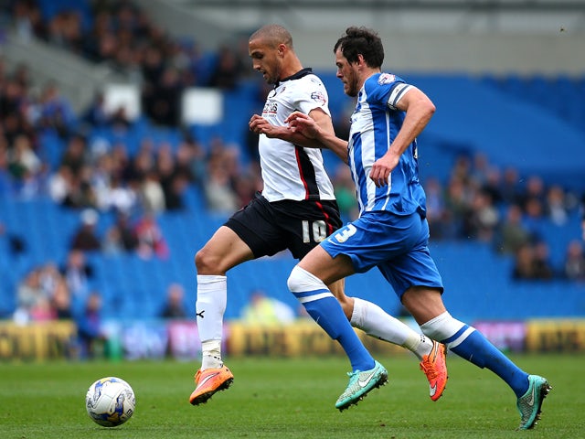 Jordan Bowery of Rotherham looks to get past Brighton's Gordon Greer during the Sky Bet Championship match between Brighton & Hove Albion and Rotherham United at The Amex Stadium on October 25, 2014