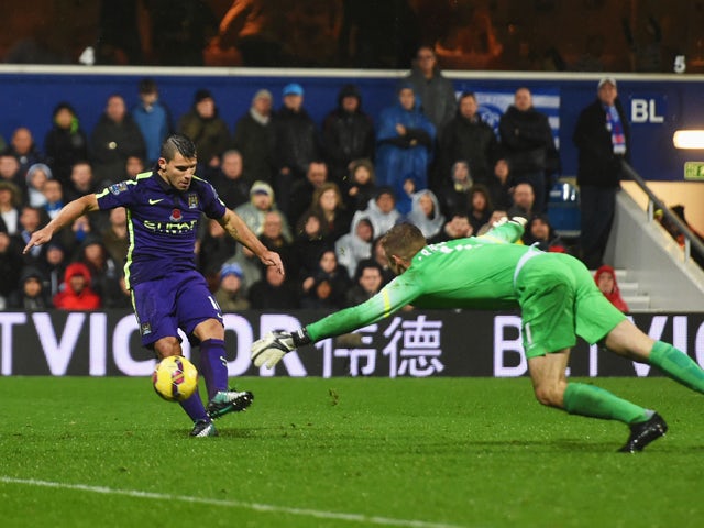 Sergio Aguero of Manchester City beats goalkeeper Robert Green of QPR to score their second goal during the Barclays Premier League match between Queens Park Rangers and Manchester City at Loftus Road on November 8, 2014 