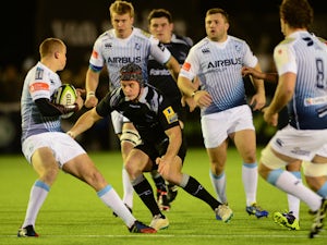 Andy Saull of Newcastle Falcons tackles Dan Fish of Cardiff Blues during the second round LV= Cup match between Newcastle Falcons and Cardiff Blues at Kingston Park on November 7, 2014